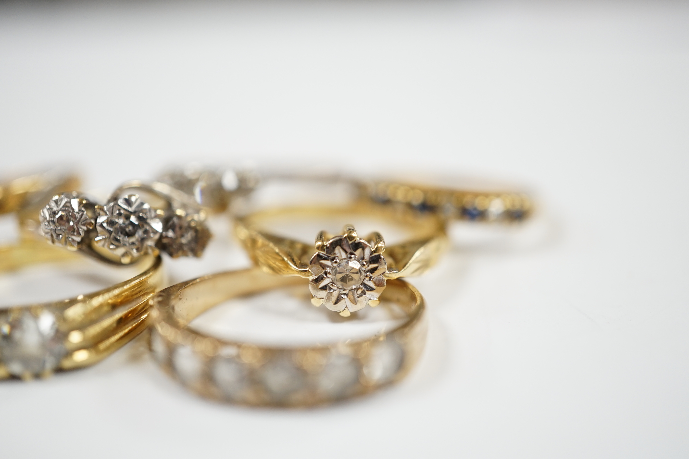 A 1920's 18ct gold and claw set solitaire diamond ring, size O, five other assorted 18ct gold and gem set rings including diamond, together wit a yellow metal and paste set half hoop ring, gross weight 17.2 grams.